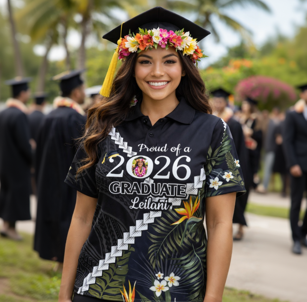 Graduate wearing a tropical-themed shirt and cap with a floral wreath, standing outdoors with other graduates in the background.